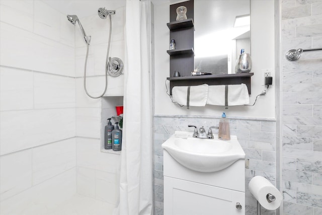 bathroom with curtained shower, vanity, and tile walls