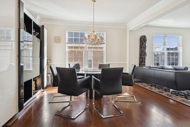 dining space featuring a notable chandelier, ornamental molding, and dark hardwood / wood-style floors