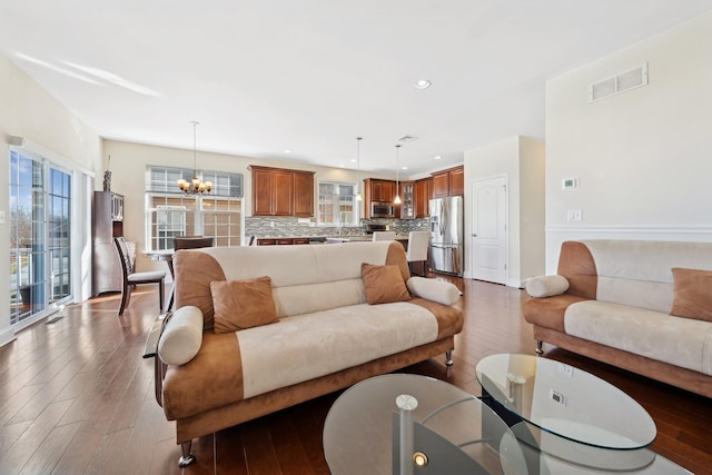 living room featuring dark hardwood / wood-style flooring and a chandelier