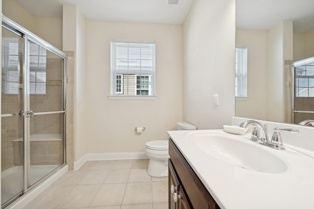 bathroom with walk in shower, vanity, tile patterned floors, and toilet