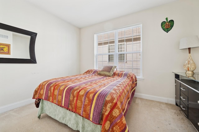 bedroom featuring light colored carpet