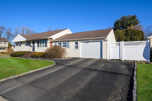 single story home featuring a front yard and a garage