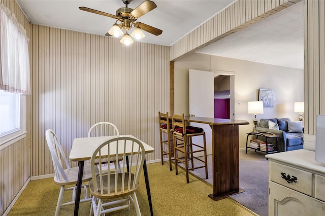 carpeted dining area featuring ceiling fan