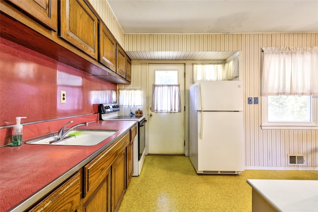 kitchen featuring white appliances and sink