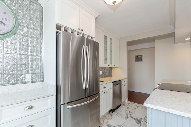 kitchen with white cabinets, stainless steel appliances, light stone counters, and tasteful backsplash