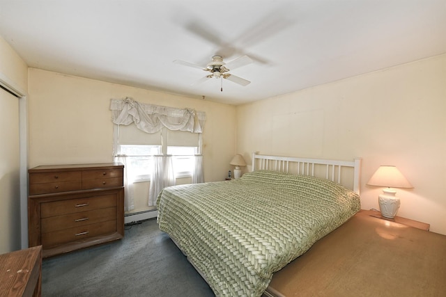 carpeted bedroom featuring ceiling fan and baseboard heating