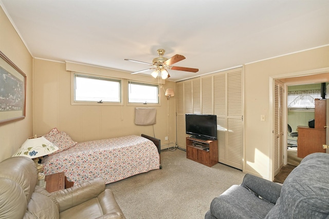 carpeted bedroom featuring a baseboard heating unit and ceiling fan