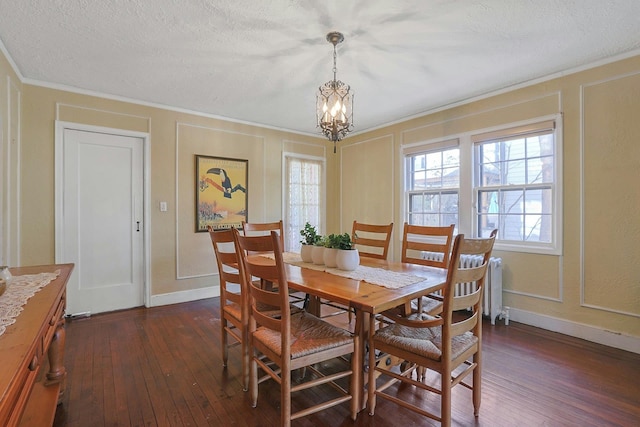 dining area featuring a textured ceiling, ornamental molding, radiator heating unit, dark hardwood / wood-style flooring, and a notable chandelier