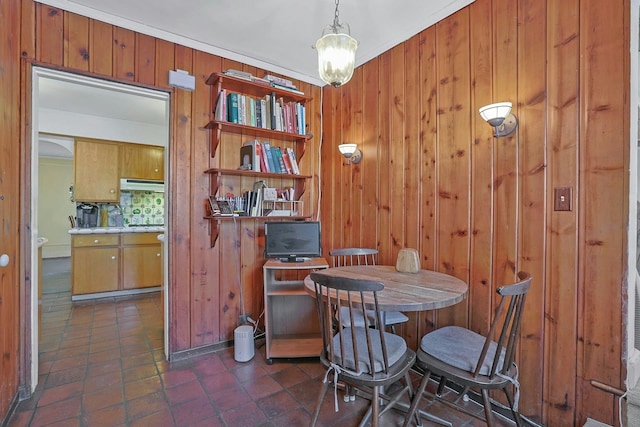 dining space with wood walls