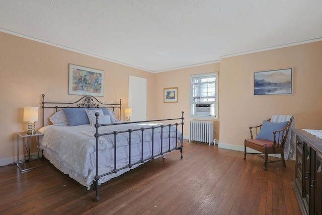 bedroom with dark hardwood / wood-style flooring, radiator, and ornamental molding