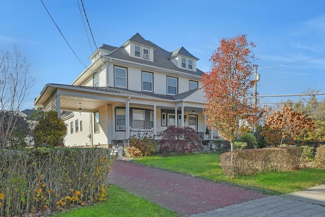 view of front of property with a porch and a front yard