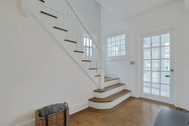 staircase featuring baseboards