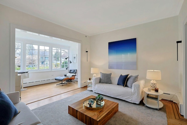 living area featuring a baseboard heating unit, crown molding, and wood finished floors