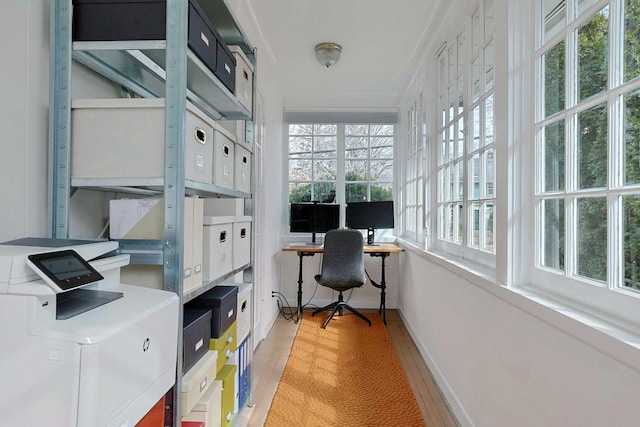 office with baseboards, light wood-style floors, and ornamental molding