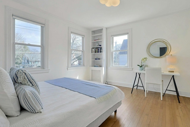 bedroom with baseboards and hardwood / wood-style floors