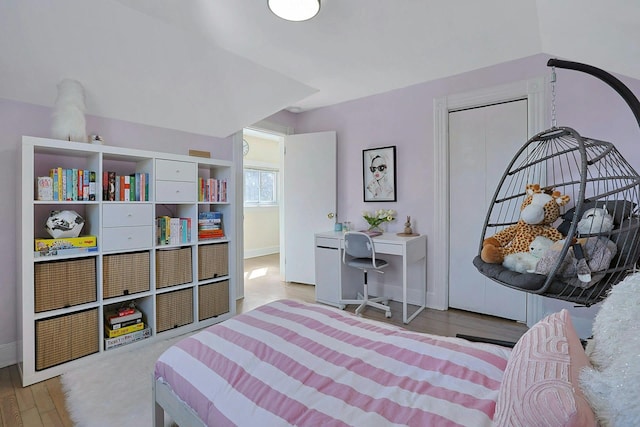 bedroom featuring baseboards and wood finished floors