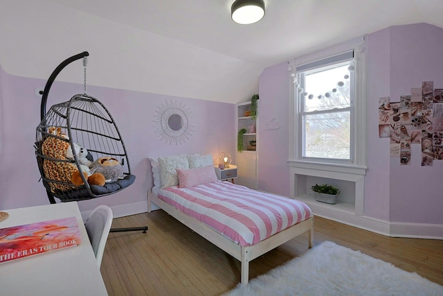 bedroom featuring baseboards, wood-type flooring, and lofted ceiling