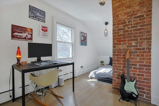 office area with a baseboard radiator and hardwood / wood-style flooring