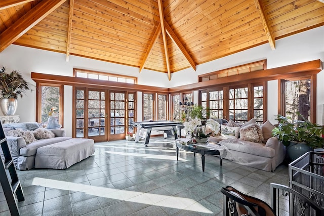 living room with french doors, pool table, beam ceiling, and high vaulted ceiling