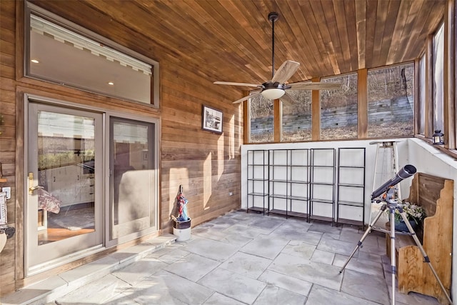 unfurnished sunroom featuring ceiling fan and wood ceiling