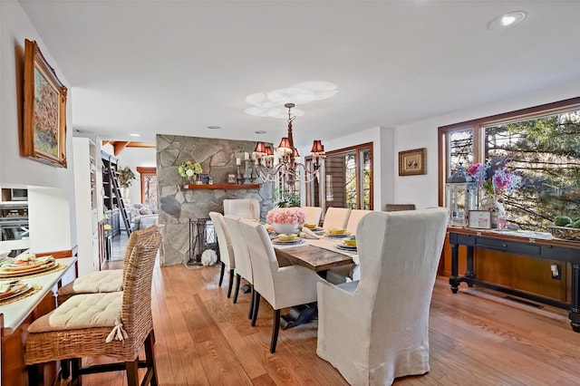 dining room featuring an inviting chandelier and light hardwood / wood-style flooring