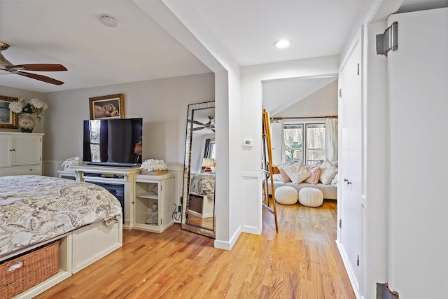 bedroom with light hardwood / wood-style flooring and ceiling fan