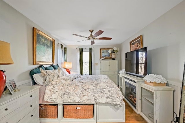 bedroom featuring ceiling fan and light hardwood / wood-style flooring