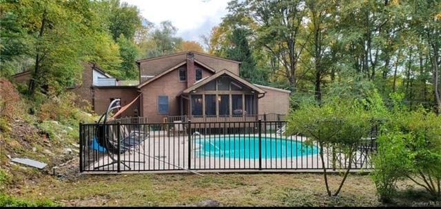 view of pool with a sunroom