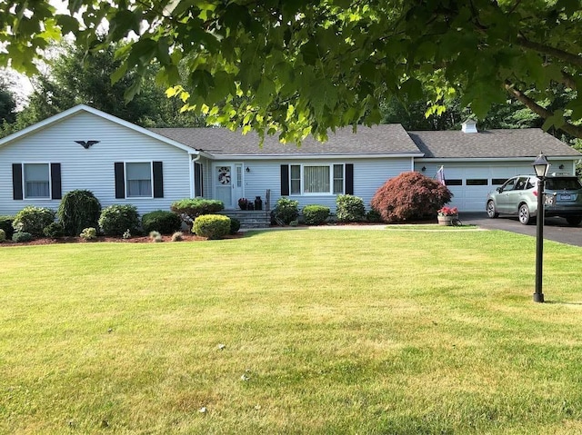 single story home with a front yard and a garage