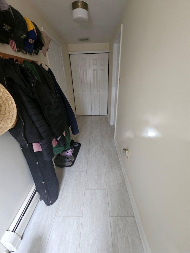 hall featuring light wood-type flooring and a baseboard radiator