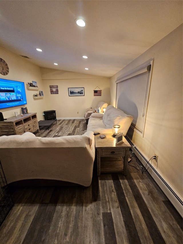 living room with dark hardwood / wood-style floors, lofted ceiling, and a baseboard heating unit