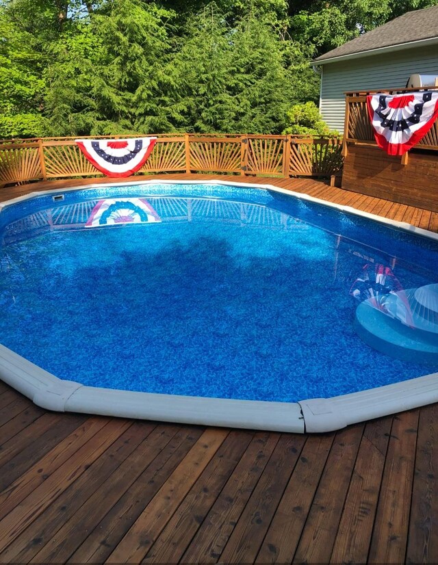 view of swimming pool featuring a deck