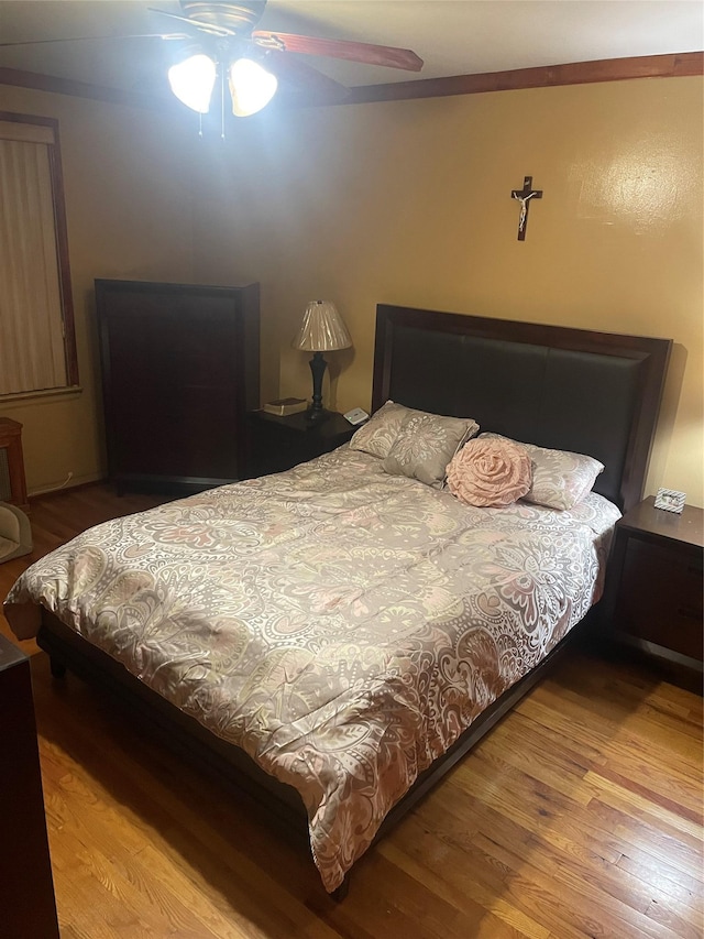 bedroom with ceiling fan and light wood-type flooring