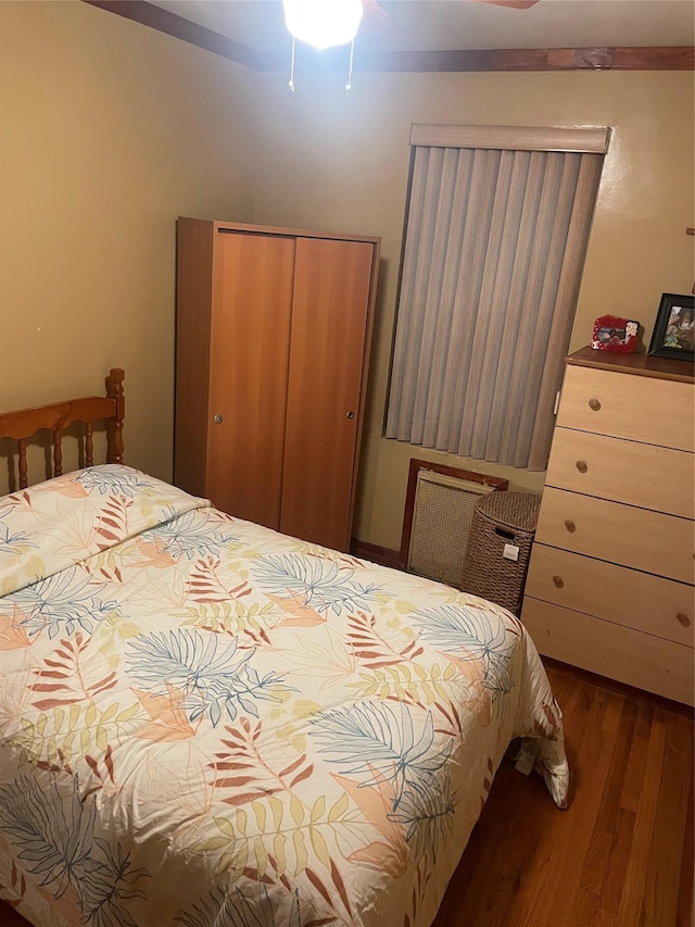 bedroom with wood-type flooring and a closet