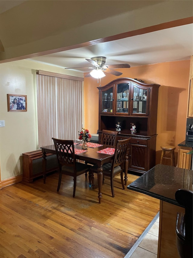 dining area with ceiling fan and light hardwood / wood-style floors