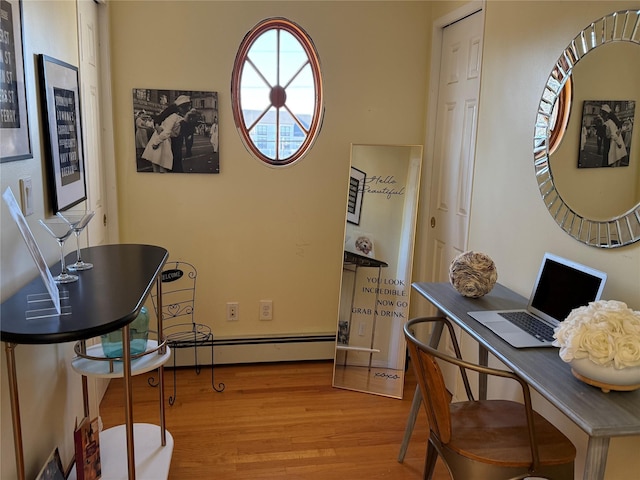 office with light hardwood / wood-style floors and baseboard heating