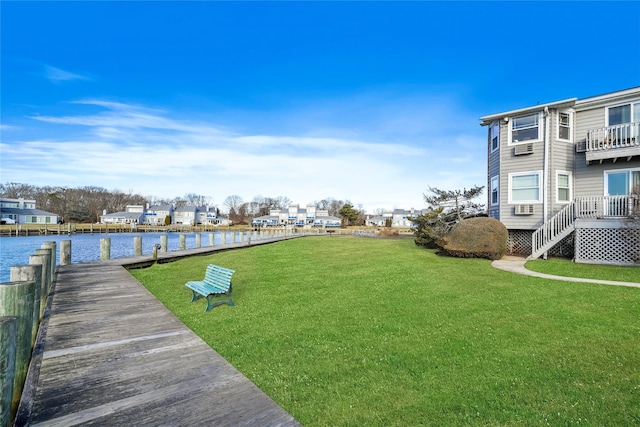 view of yard with a water view and a boat dock