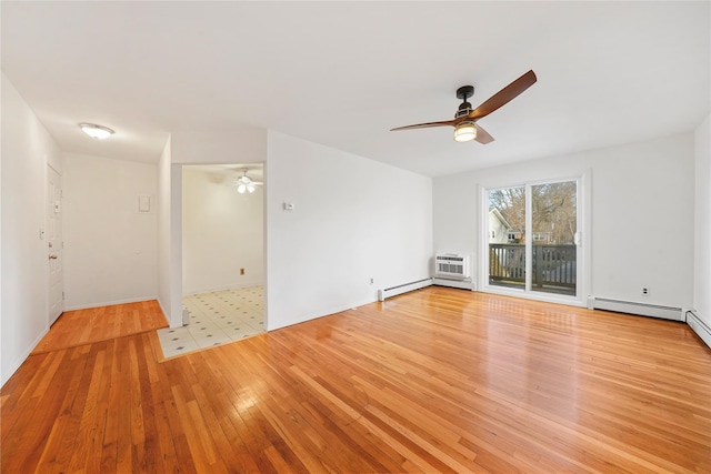 spare room featuring ceiling fan, light hardwood / wood-style flooring, and a baseboard radiator