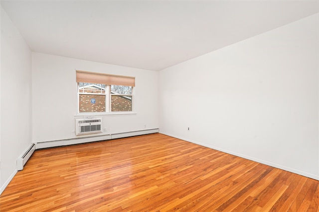 empty room featuring a baseboard radiator, light hardwood / wood-style floors, and a wall mounted air conditioner