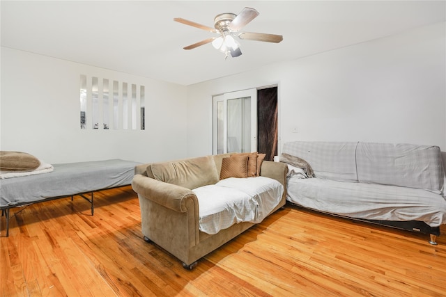 living room featuring hardwood / wood-style floors and ceiling fan