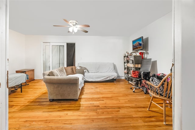 living room with ceiling fan and light hardwood / wood-style floors