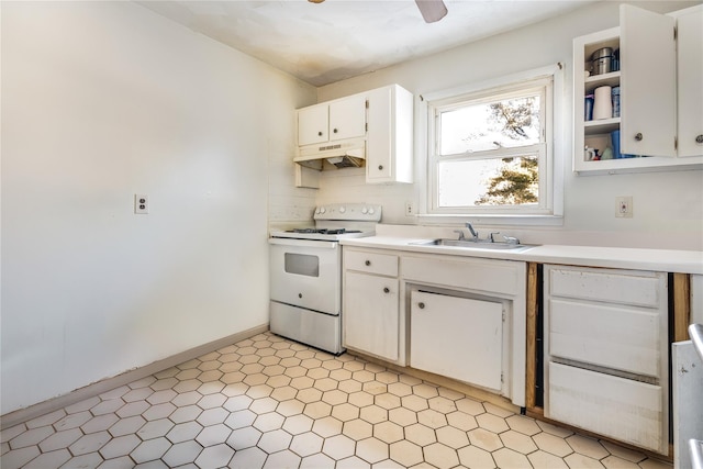 kitchen with sink, white cabinetry, and electric stove