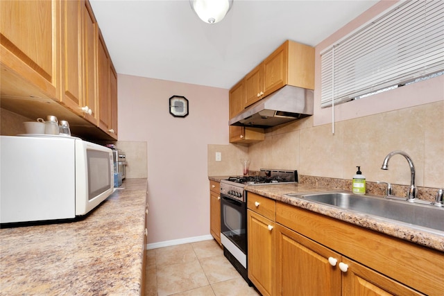 kitchen featuring light tile patterned flooring, gas range oven, decorative backsplash, and sink