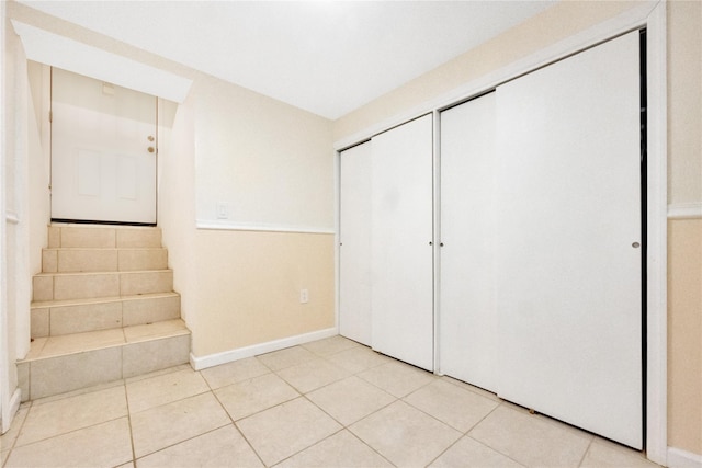 interior space featuring light tile patterned floors and a closet