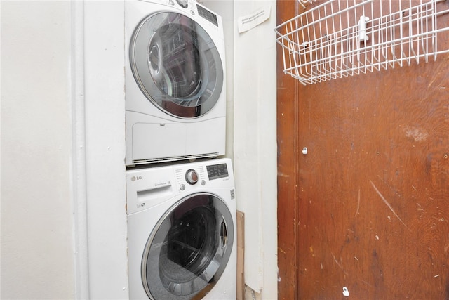 laundry room with stacked washing maching and dryer