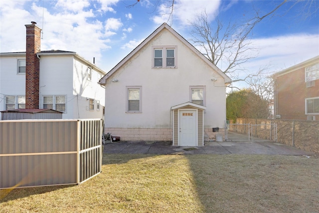 rear view of property featuring a yard