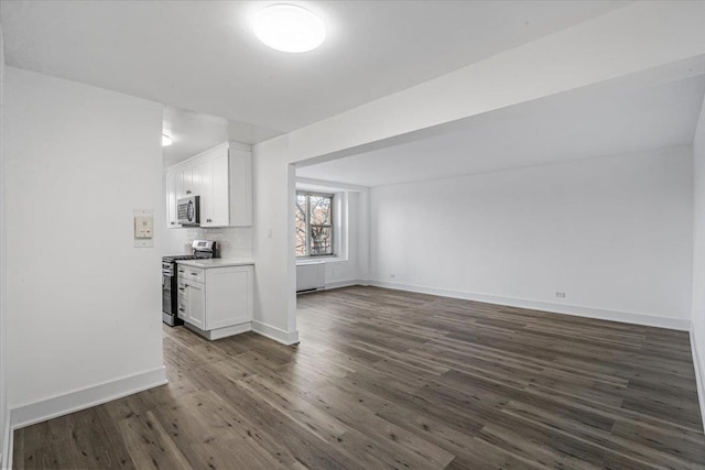 unfurnished living room with dark hardwood / wood-style floors