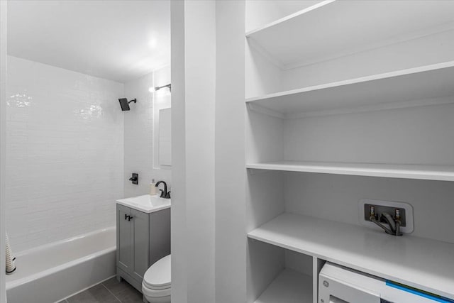 full bathroom featuring tile patterned flooring, vanity, toilet, and tiled shower / bath combo