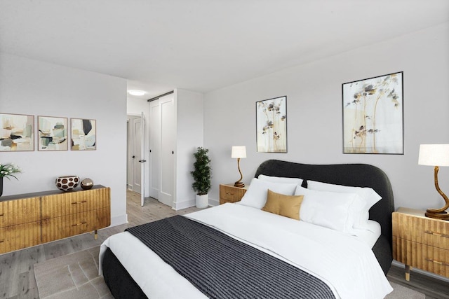 bedroom featuring a closet and light hardwood / wood-style flooring