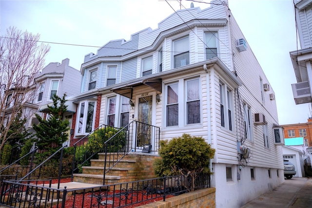 view of front of house with a wall mounted AC